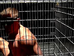 Muscular man Tyler Saint gets blindfolded and caged 